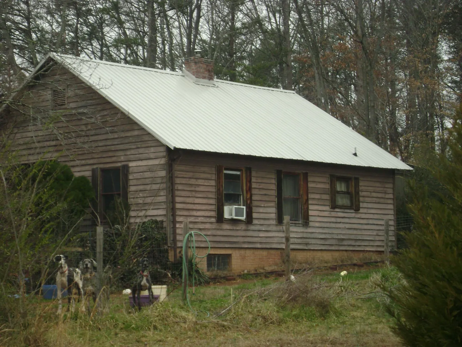 White metal roof on an old wood sided farmhouse, from a Metal Roof Installation job in Grimesland